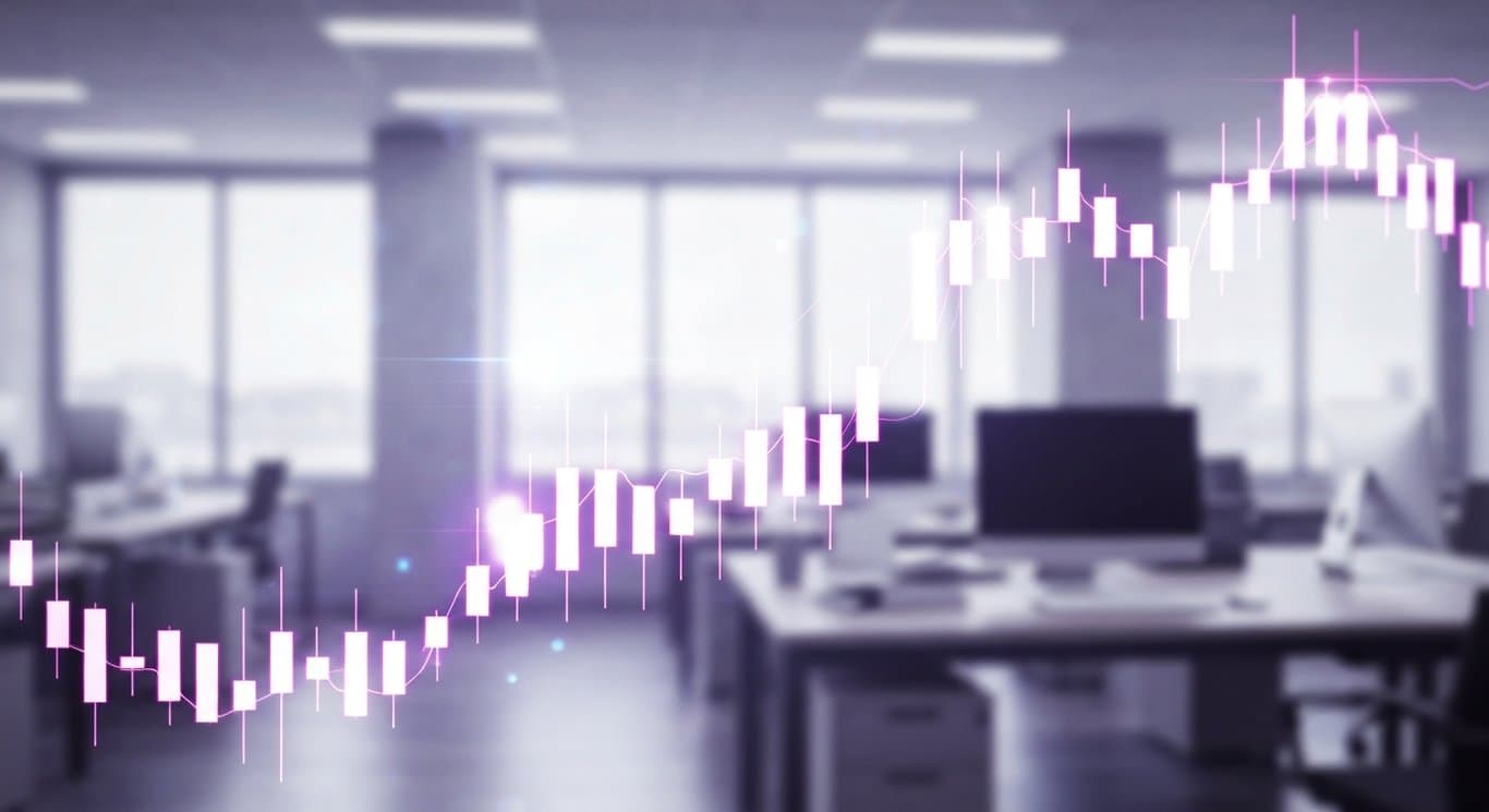 Digital stock chart with rising candlesticks in front of a blurred financial office background