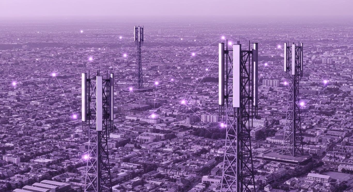 Cellular network towers among city buildings with faint glowing connections and a purple-toned background