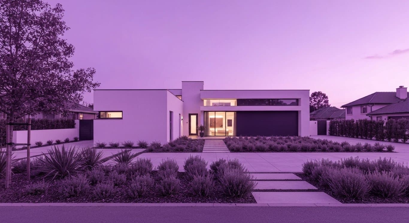 Modern suburban house with clean lines in a peaceful landscaped neighborhood at dusk